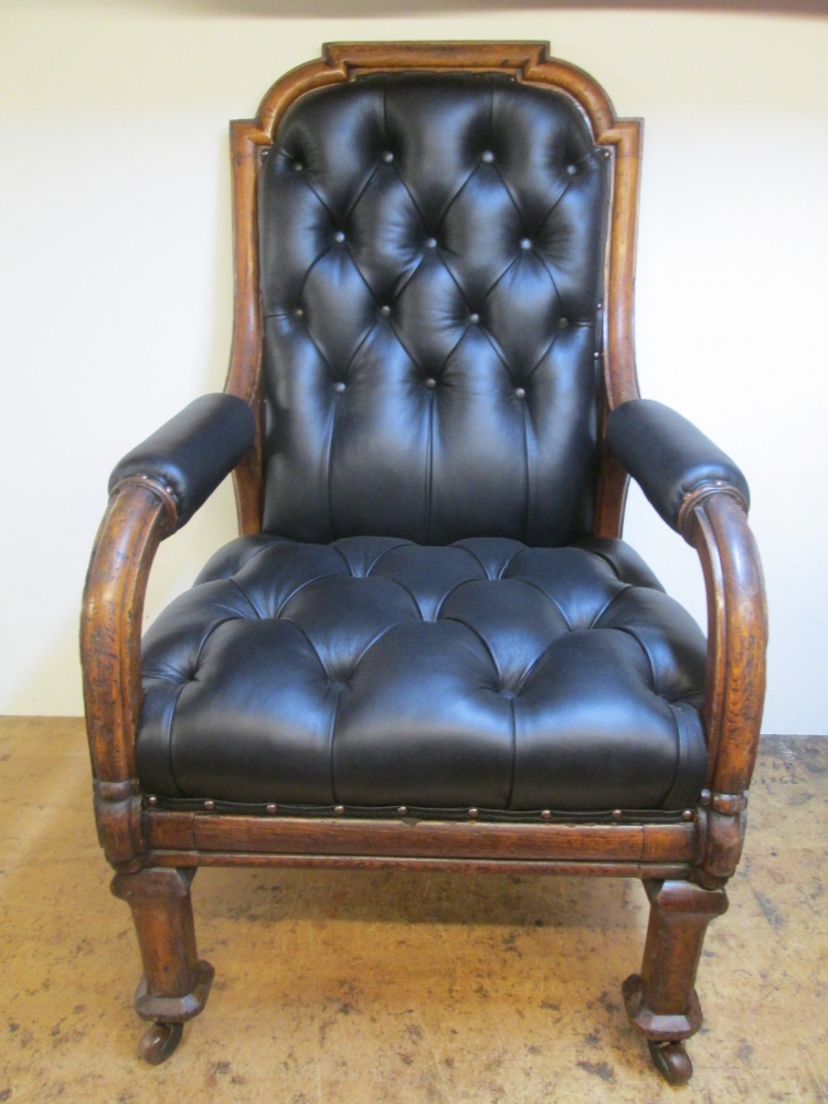 The same Oxford Union chair after, in new buttoned black leather