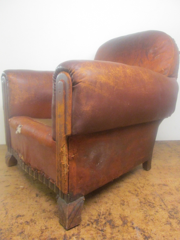 An Art Deco leather club armchair before restoration